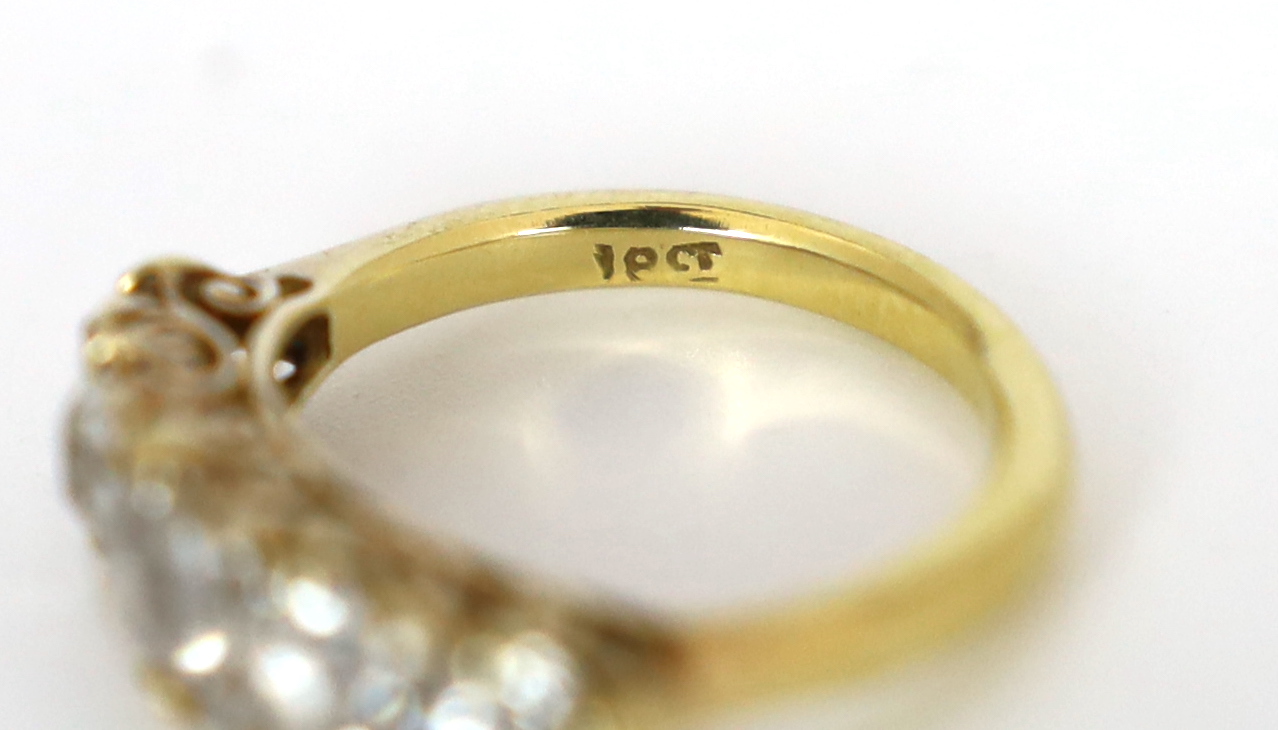 An early 20th century 18ct gold and graduated old round cut diamond set half hoop ring